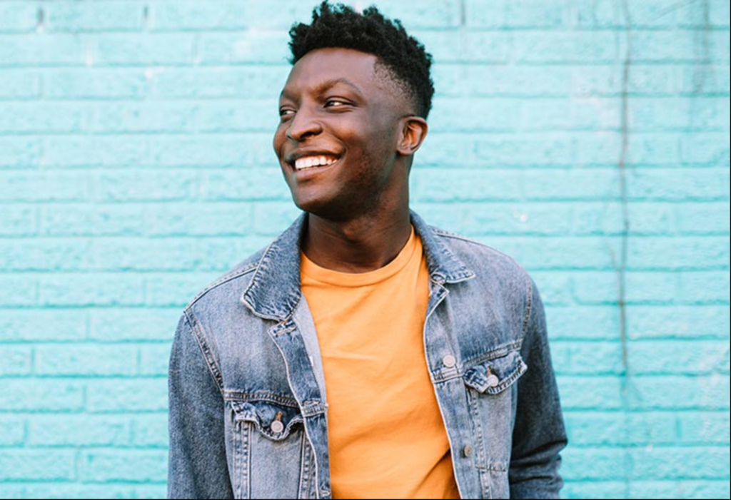 A person standing on a bright blue background